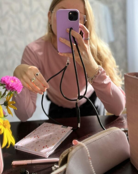 1. Woman using SEIK Universal Phone Strap in Midnight, showcasing hands-free phone accessibility