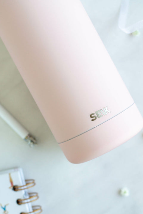 4. Close-up of SEIK logo on pink water bottle with non-slip design