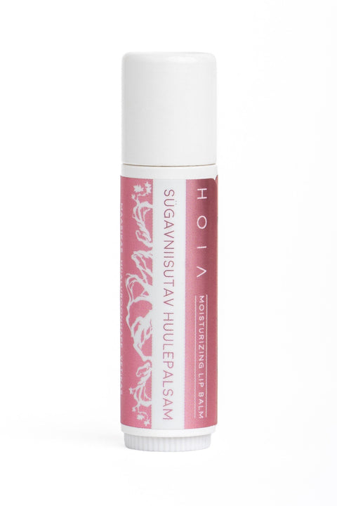 2. Studio image of HOIA homespa deeply hydrating lip balm, featuring pink label with floral design