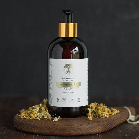 1. HOIA homespa Intimate Wash Gel with Chamomile, 250ml bottle on wooden board with chamomile flowers, highlighting pH-balanced, fragrance-free formula