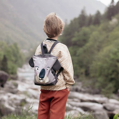 3. Child wearing Muni Koala backpack in nature, emphasizing playful design and comfort