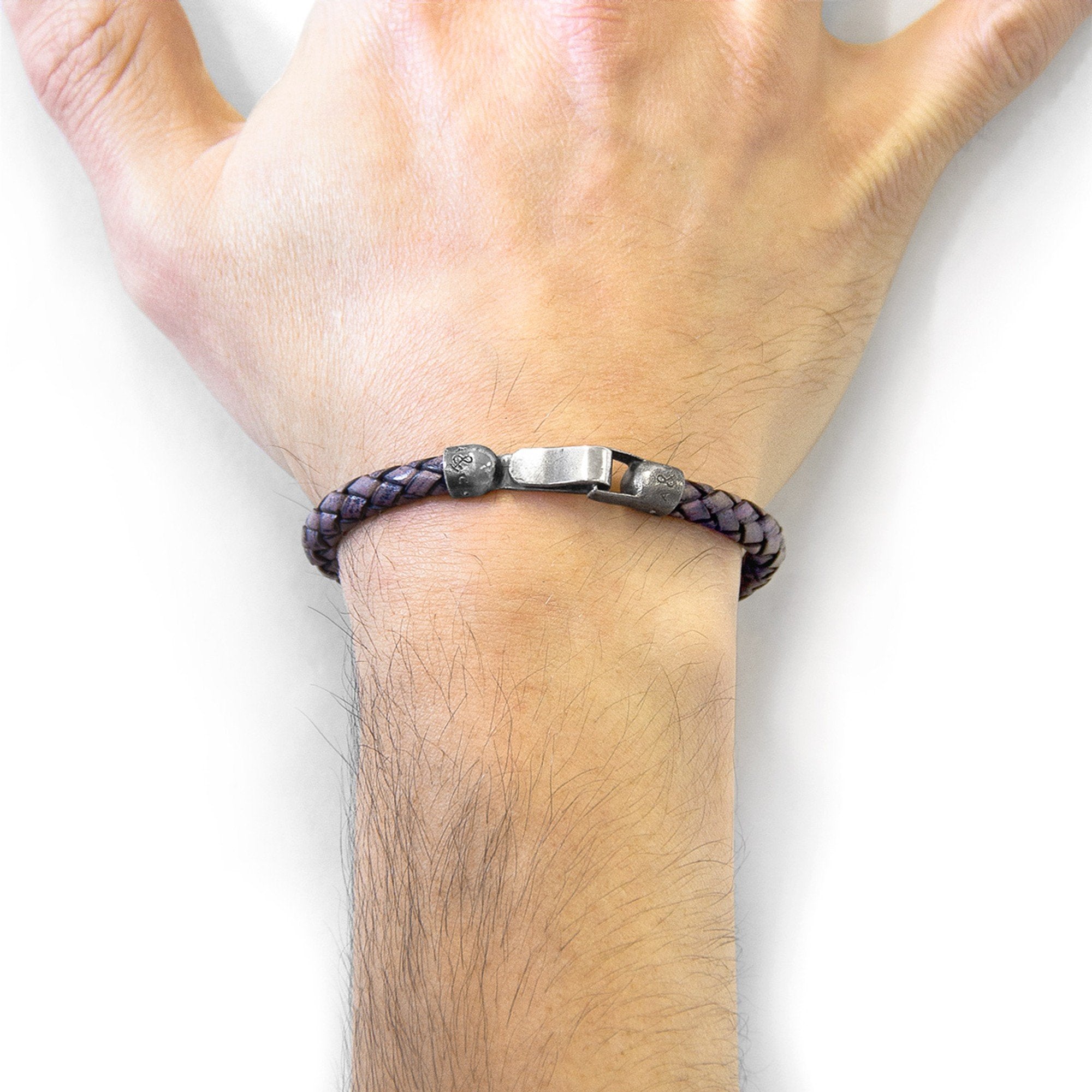 1. Men's indigo blue braided leather bracelet by ANCHOR & CREW, worn on wrist with sterling silver clasp