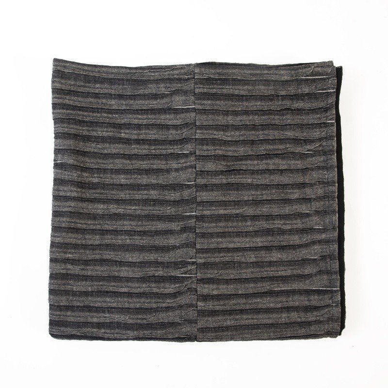 5. Flat lay of black and gray linen-cotton bedcover showing corrugated weave and folded design
