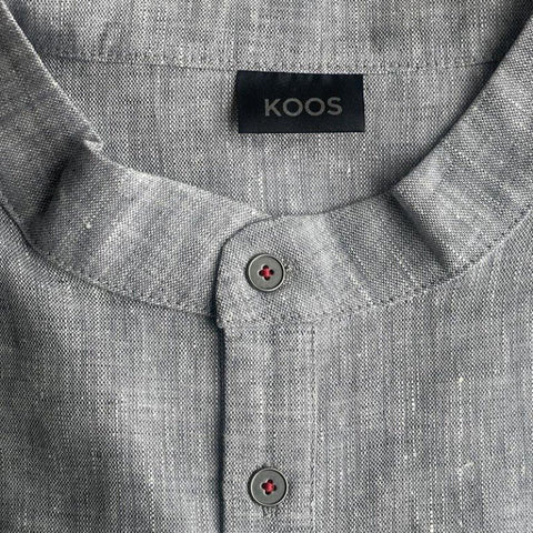 4. Close-up of blue-gray linen dress collar with KOOS label and metal buttons
