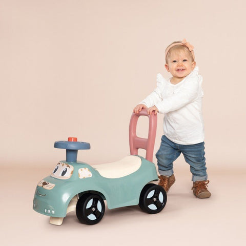 1. Toddler pushing Smoby Little Ride-on Pusher in pastel colors, indoor setting
