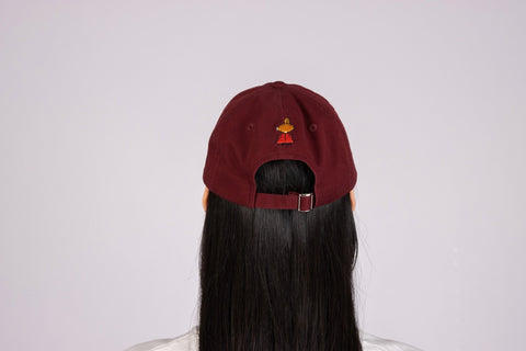4. Back view of red Little My Dad Cap by Moomin, worn by model, showing adjustable strap