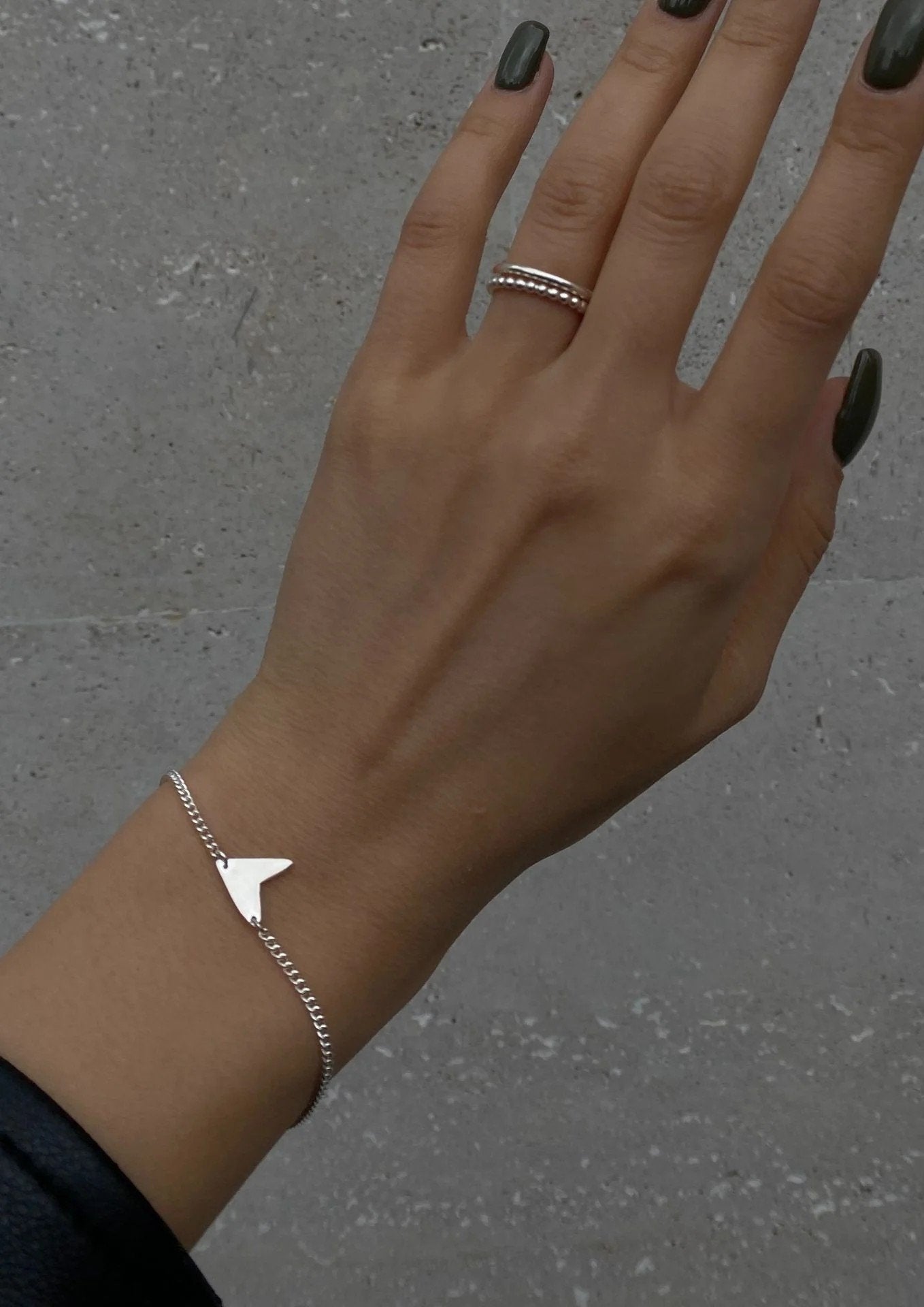 6. Women's Love Bracelet in silver worn with denim, showcasing casual and chic look