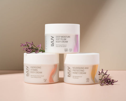 3. LUUV body cream trio with Nourishing and Protecting Honey Cream, Deep Moisture Soft Plum, and Energizing Vitamin Creams, styled with flowers