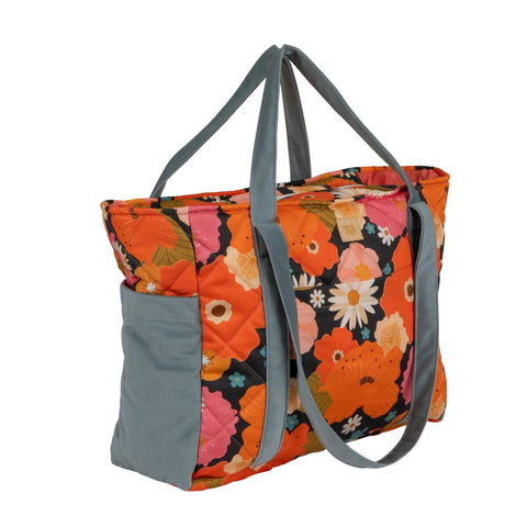 2. Side view of floral weekender bag with blue straps, featuring vibrant orange, pink, and white flowers on a black background.