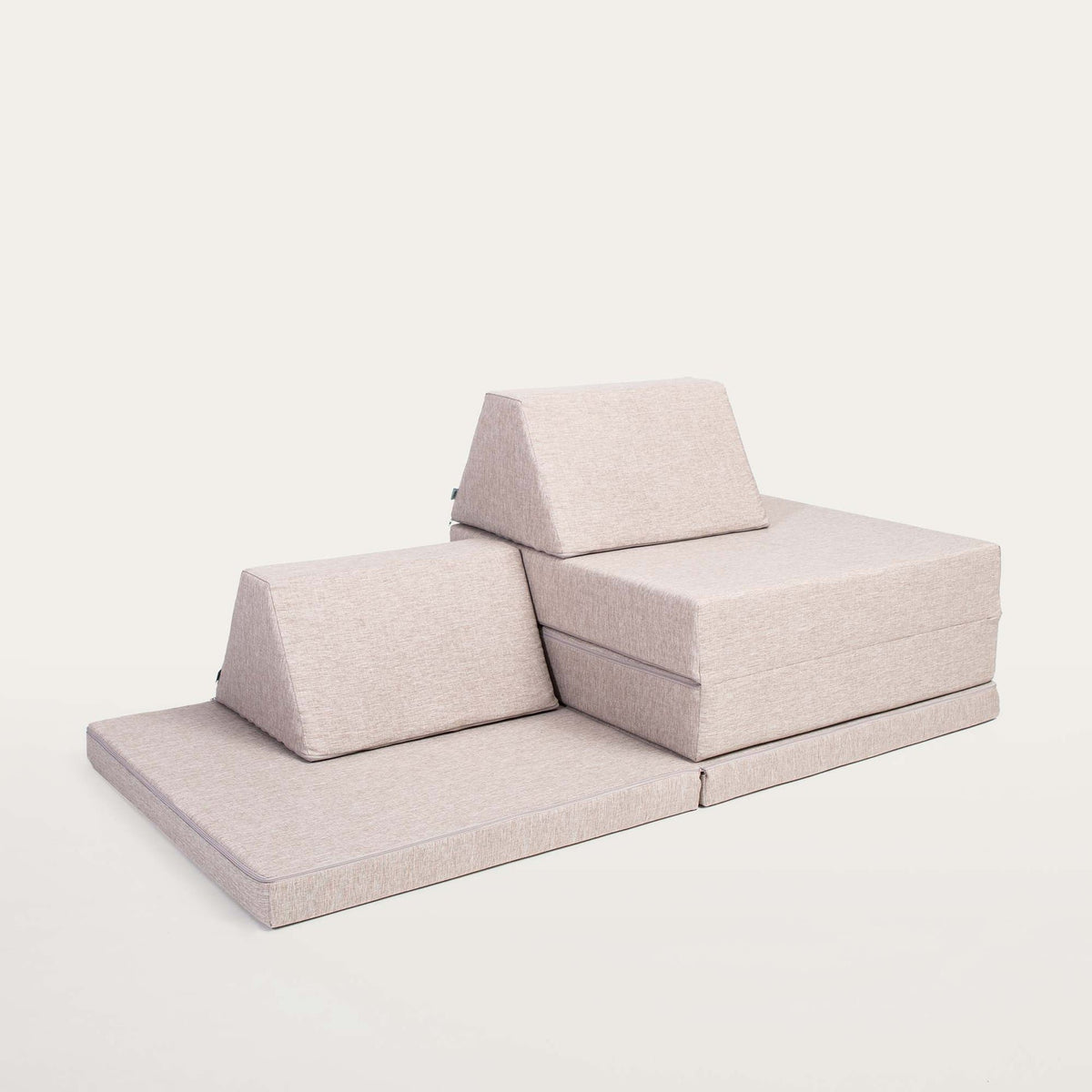 12. Beige Monboxy play mattress set with trapezoidal pillows on a white background