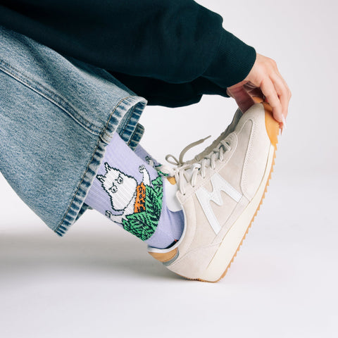 1. Women's Moomin Jungle Retro Socks in purple worn with sneakers, showcasing playful design