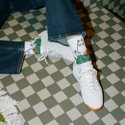 1. Women's Moomin Jungle Retro Socks in white worn with jeans and sneakers, lifestyle setting