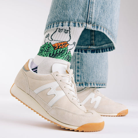 1. Women's Moomin Jungle Retro Socks in white worn with jeans and sneakers, showcasing playful design