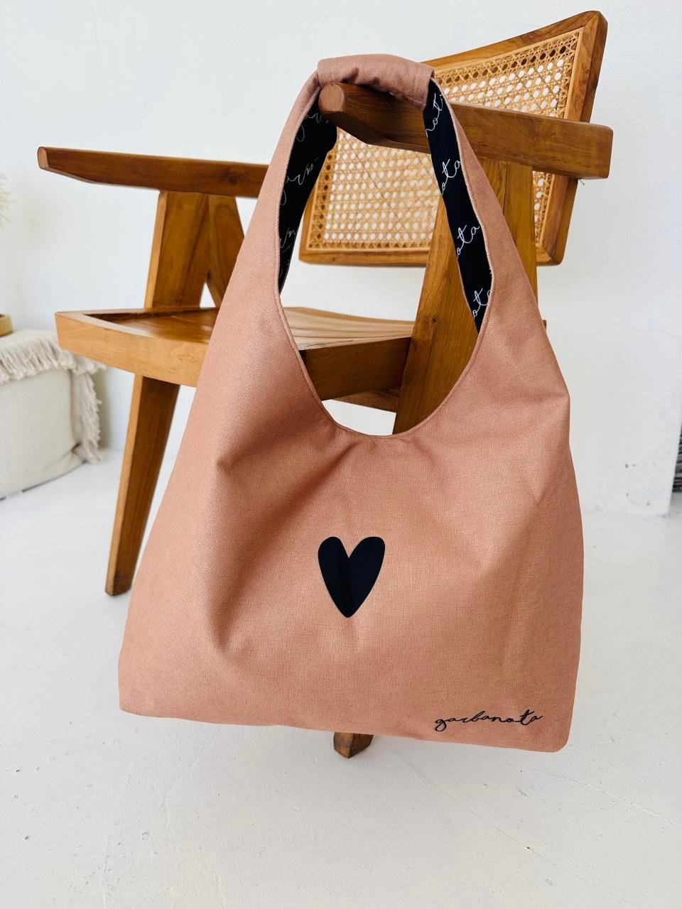 4. Garbanota Moon Bag Heart in cream, displayed on wooden chair, highlighting interior pattern