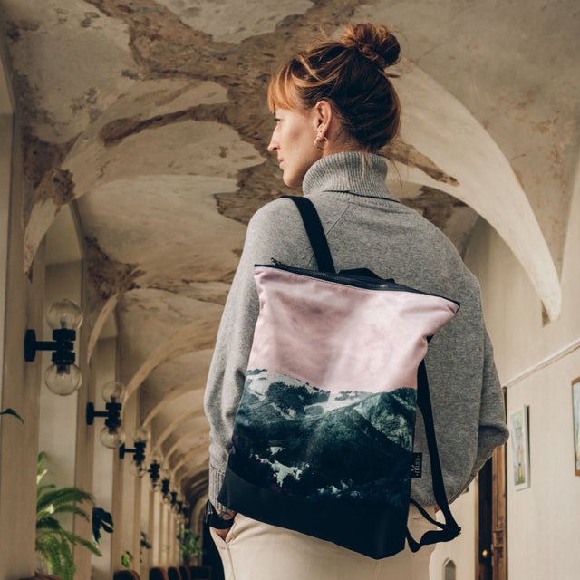 1. Woman wearing Muni Blue Mountains backpack in lifestyle setting, showcasing stylish design