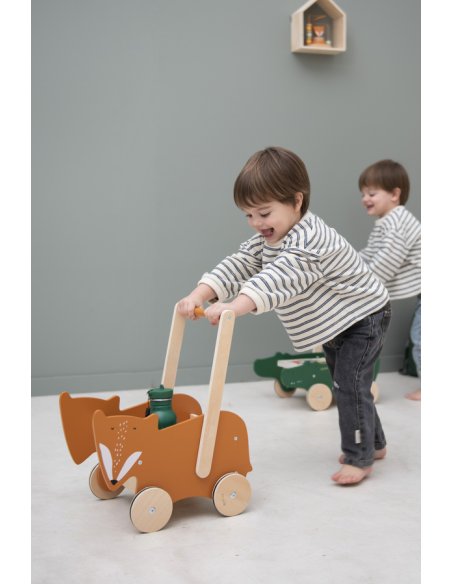 2. Two children playing with wooden carts, one with Mr. Fox design, in a playroom
