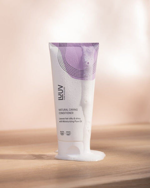 1. LUUV Natural Nourishing Conditioner with Plum Oil, 200 ml, shown with creamy texture on wooden surface