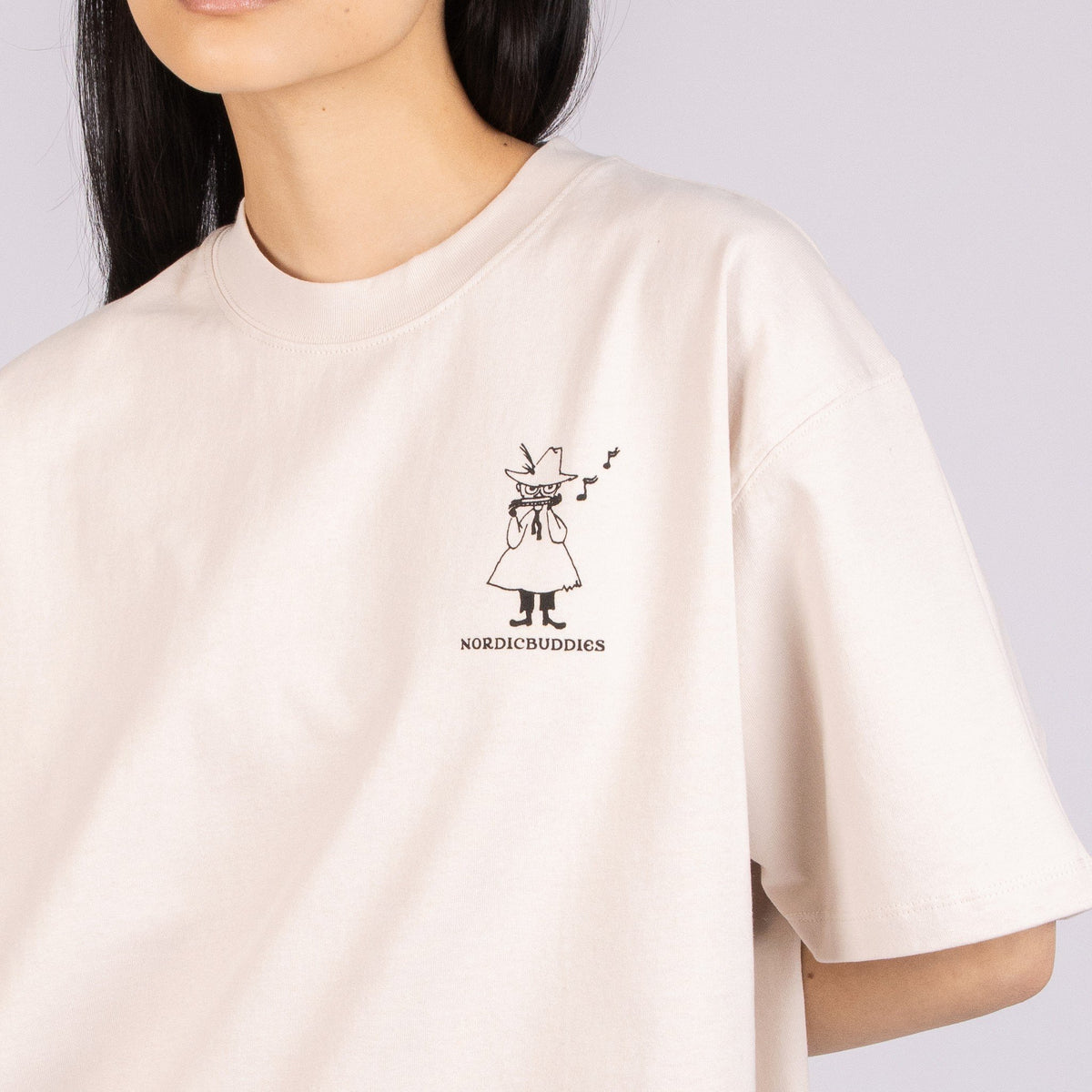 5. Close-up of unisex beige Moomin t-shirt, featuring NordicBuddies logo on front