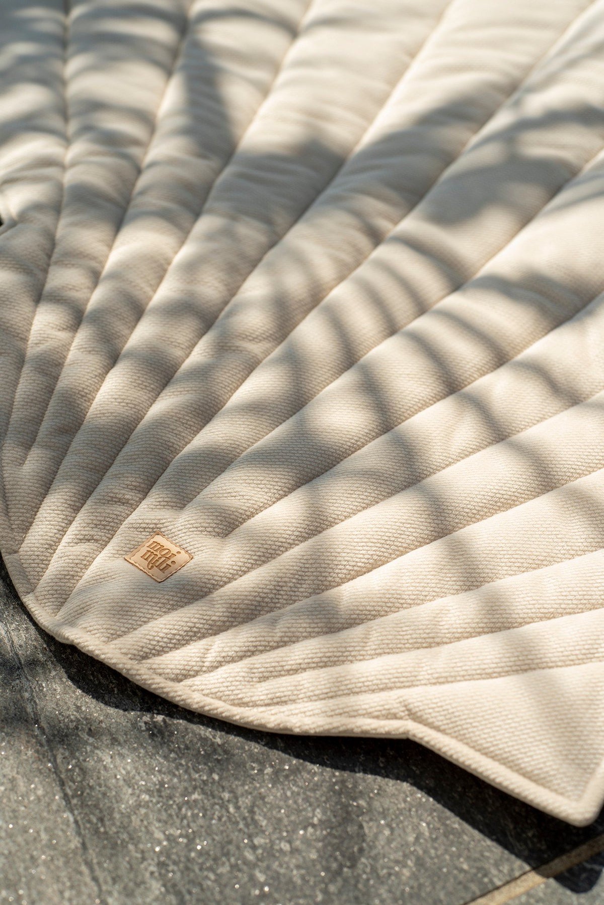 8. Close-up of beige ginkgo leaf-shaped playmat with shadow patterns