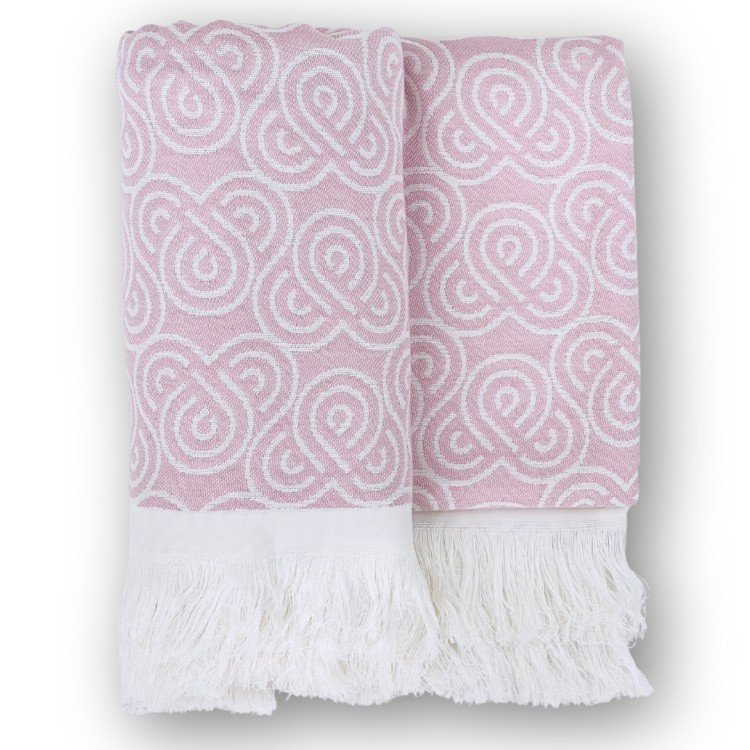 3. Pink bamboo towel with white loop pattern and fringed edges, folded on a white background