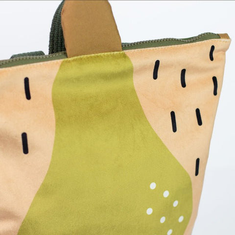5. Close-up of Muni PEAR backpack showing pear design and zipper detail