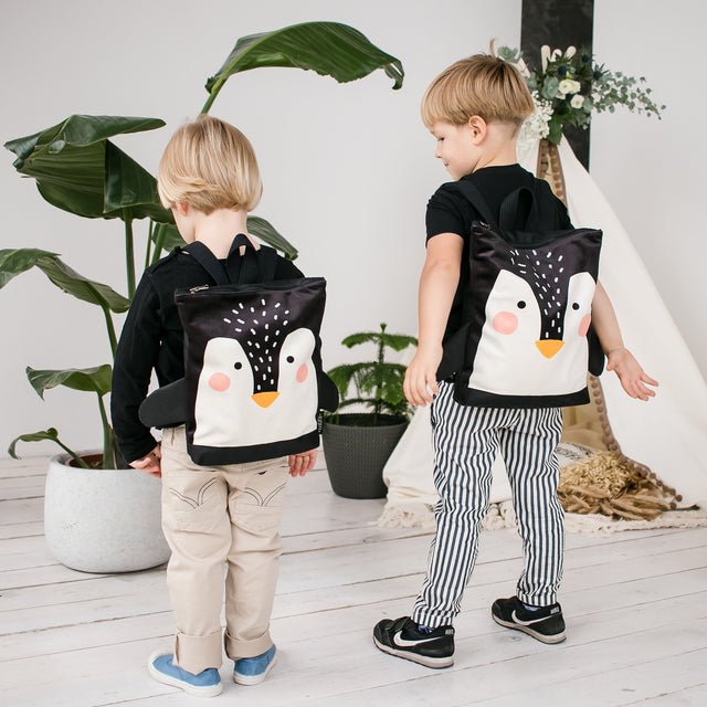 9. Children with Muni Penguin backpacks in a stylish indoor environment