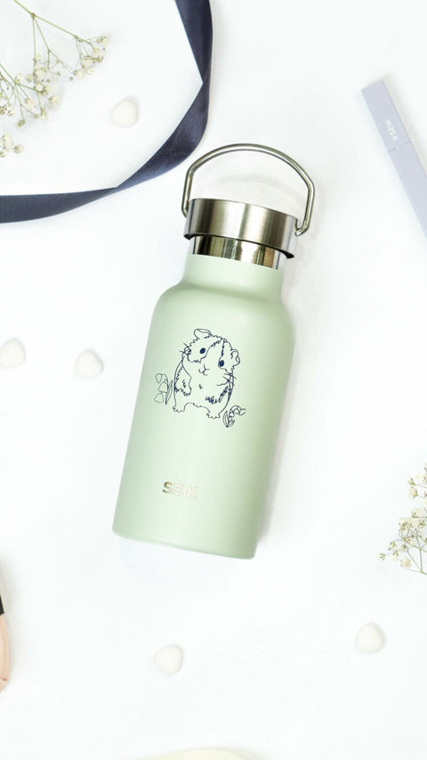 4. Close-up of SEIK light green water bottle with guinea pig design and stainless steel cap