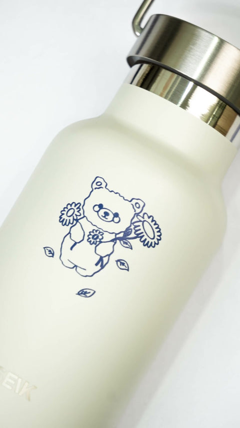 2. Close-up of SEIK beige water bottle featuring playful bear illustration and stainless steel cap