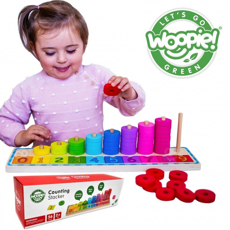 10. Child in pink polka dot sweater playing with colorful wooden counting puzzle, Woopie Let's Go Green logo visible