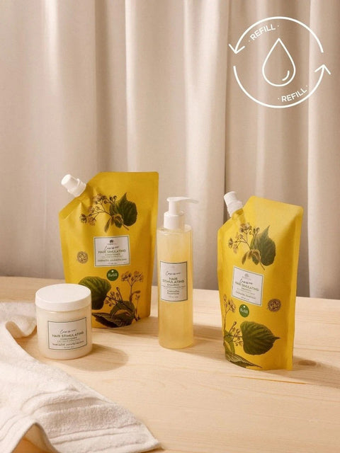 2. Magrada Organic Cosmetics linden flower conditioner refill and other products on wooden surface, highlighting sustainable packaging