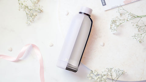 4. Close-up of SEIK water bottle with a sleek design, surrounded by delicate flowers