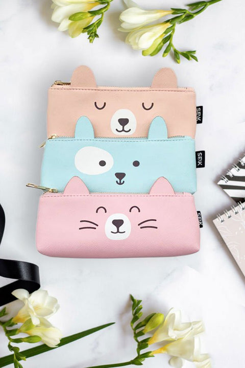 2. Trio of SEIK pencil cases featuring bear, dog, and cat designs in pastel colors, displayed with flowers and notebooks