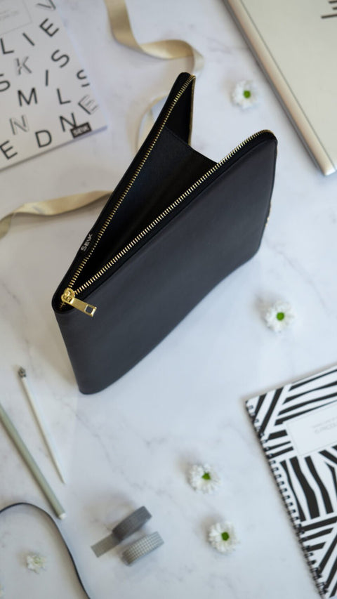 3. SEIK Dream.Plan.Do laptop sleeve standing upright with open zipper, showcasing minimalist design and gold accents