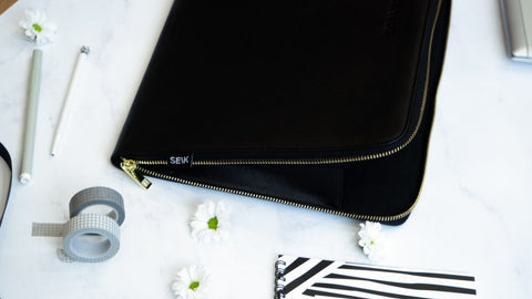 4. SEIK Dream.Plan.Do laptop sleeve partially open, displaying SEIK branding and gold zipper detail