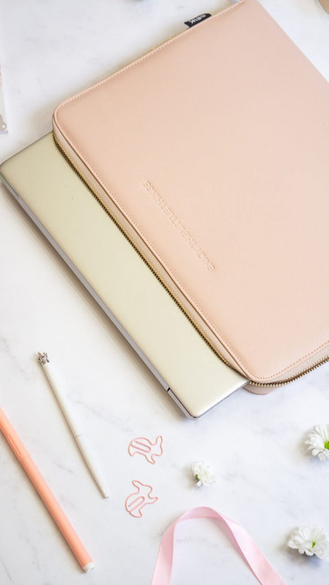 3. SEIK pink laptop sleeve partially covering a laptop, highlighting sleek design