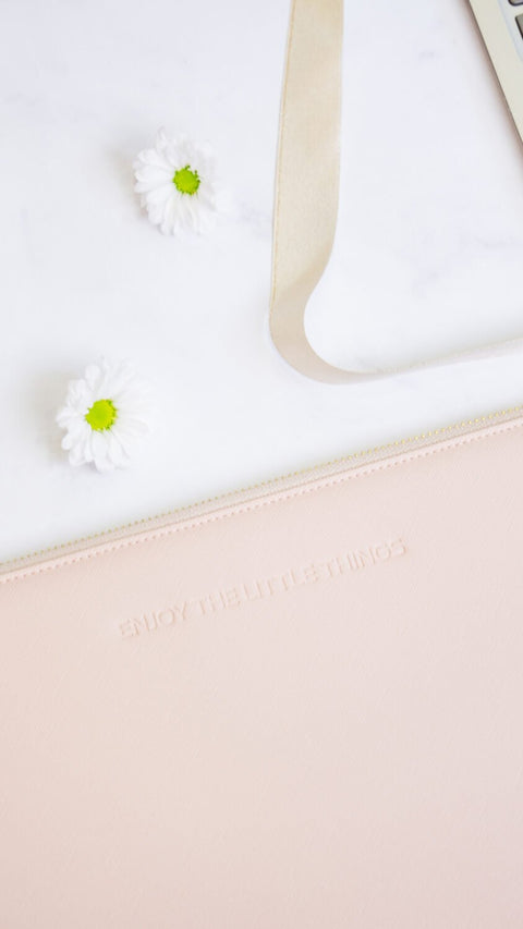 4. Close-up of SEIK pink laptop sleeve with 'Enjoy the little things' embossed text