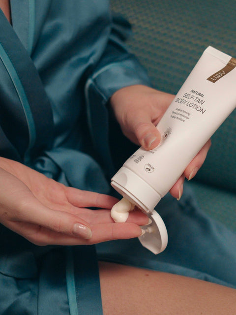 3. Close-up of LUUV self-tanning body lotion being dispensed onto hand