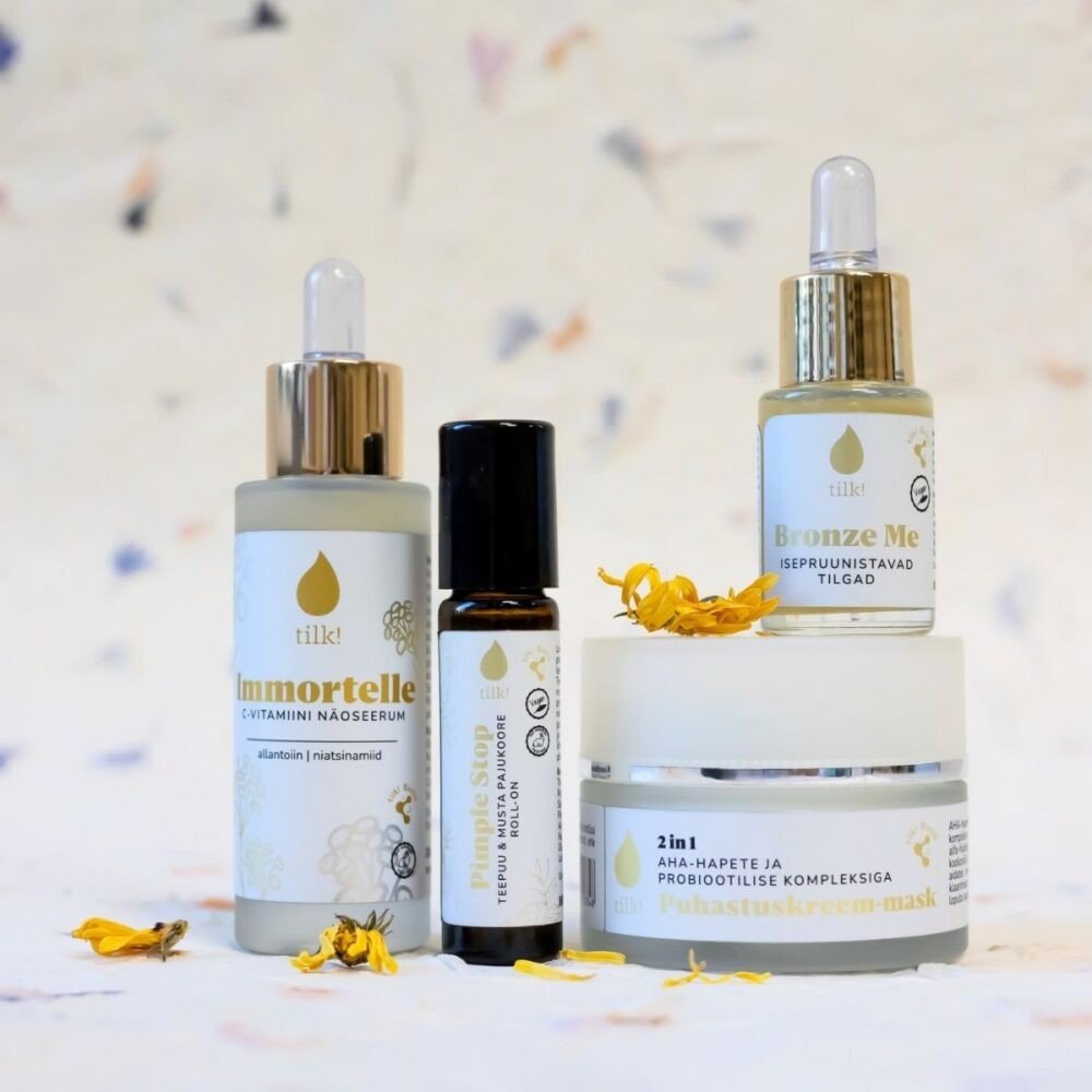 2. Collection of Tilk! skincare products including Self-Tanning Drops, Immortelle serum, and 2in1 mask, displayed with floral accents