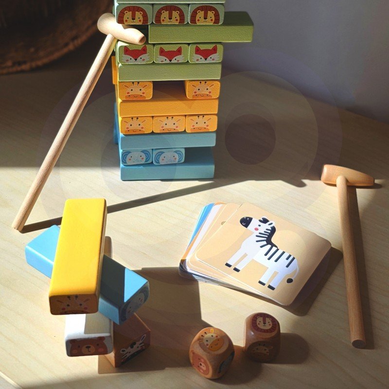 14. Shaky Tower game components including pastel animal blocks, dice, and cards on a table
