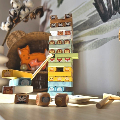 1. Shaky Tower skill game with pastel-colored wooden blocks and animal designs on a table with a cozy background