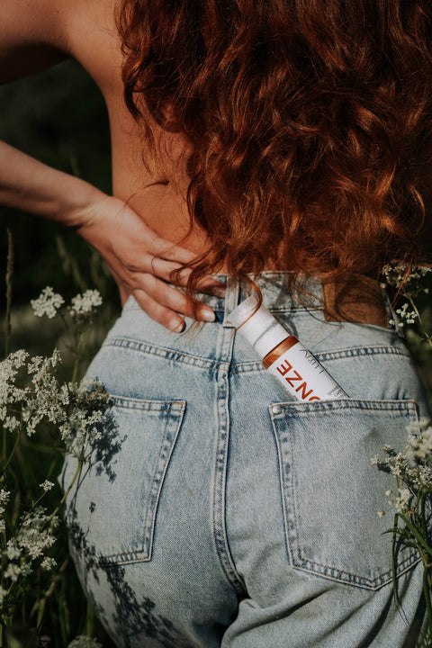 1. LUUV Shimmering Carrot Dry Oil Bronze in back pocket of jeans, outdoor setting