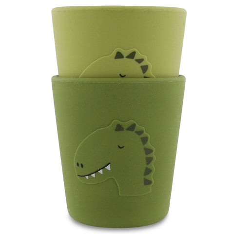 2. Two green silicone cups with dinosaur design, stackable, on white background
