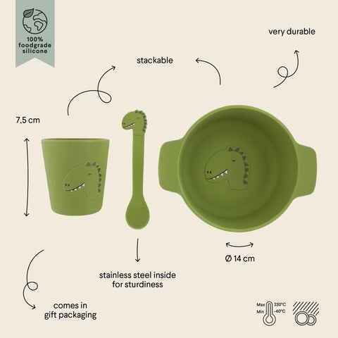 2. Green silicone meal set for kids with dinosaur designs, labeled with dimensions and features, on beige background