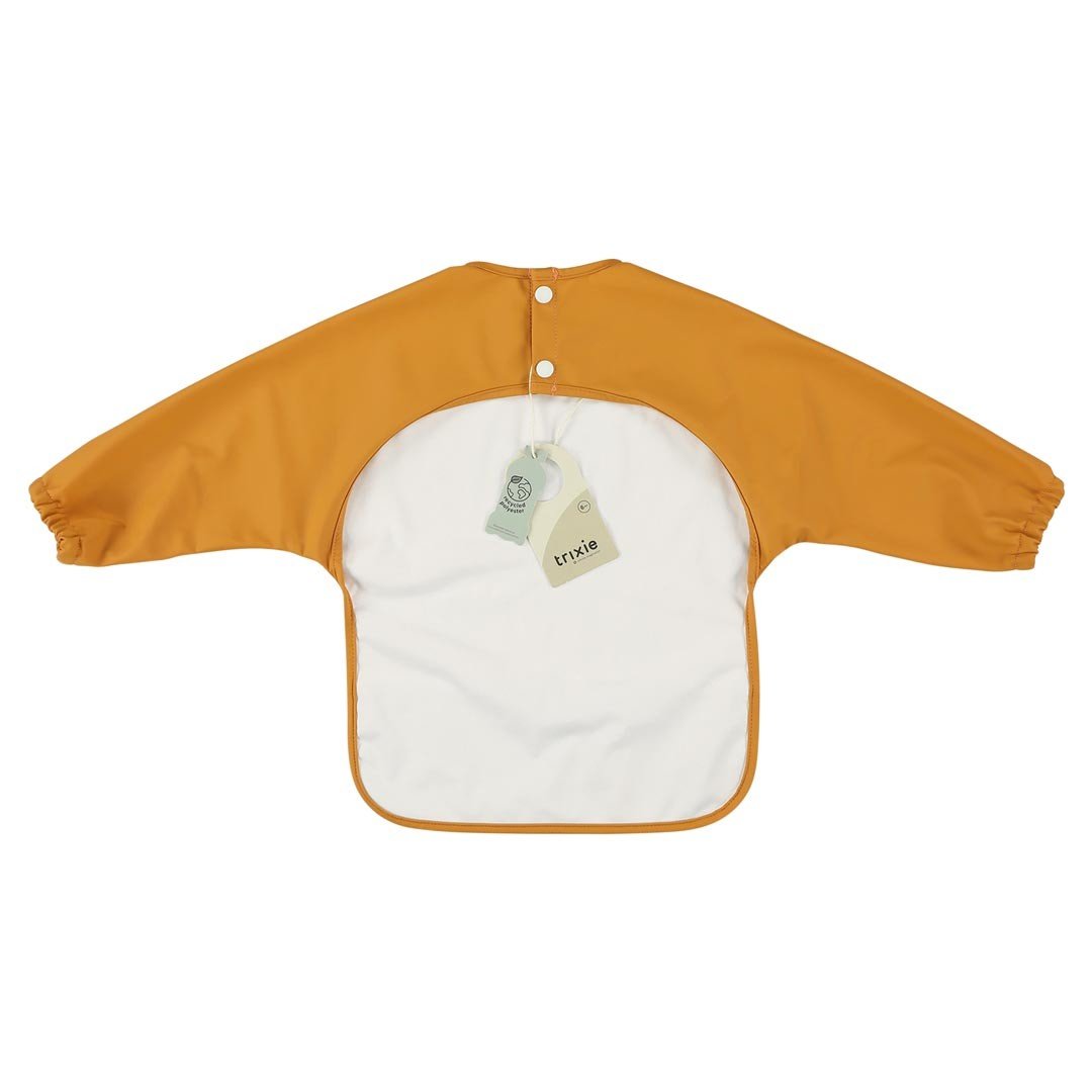 2. Back view of orange Trixie Baby waterproof long sleeve bib with white lining and snap closures