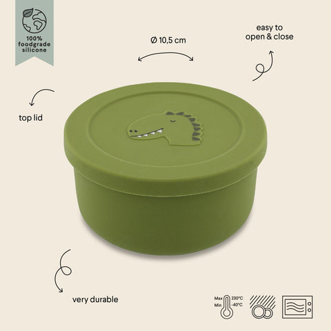 2. Green silicone snack container with dinosaur design, labeled features including easy open lid and durability, by Trixie Baby