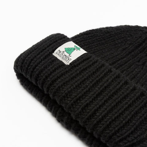 3. Close-up of black chunky beanie showing Moomin by NordicBuddies logo on ribbed fabric