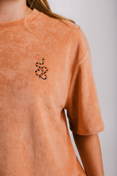 4. Close-up of Sossu Coral Snake Terry T-shirt in brown showing embroidered snake detail