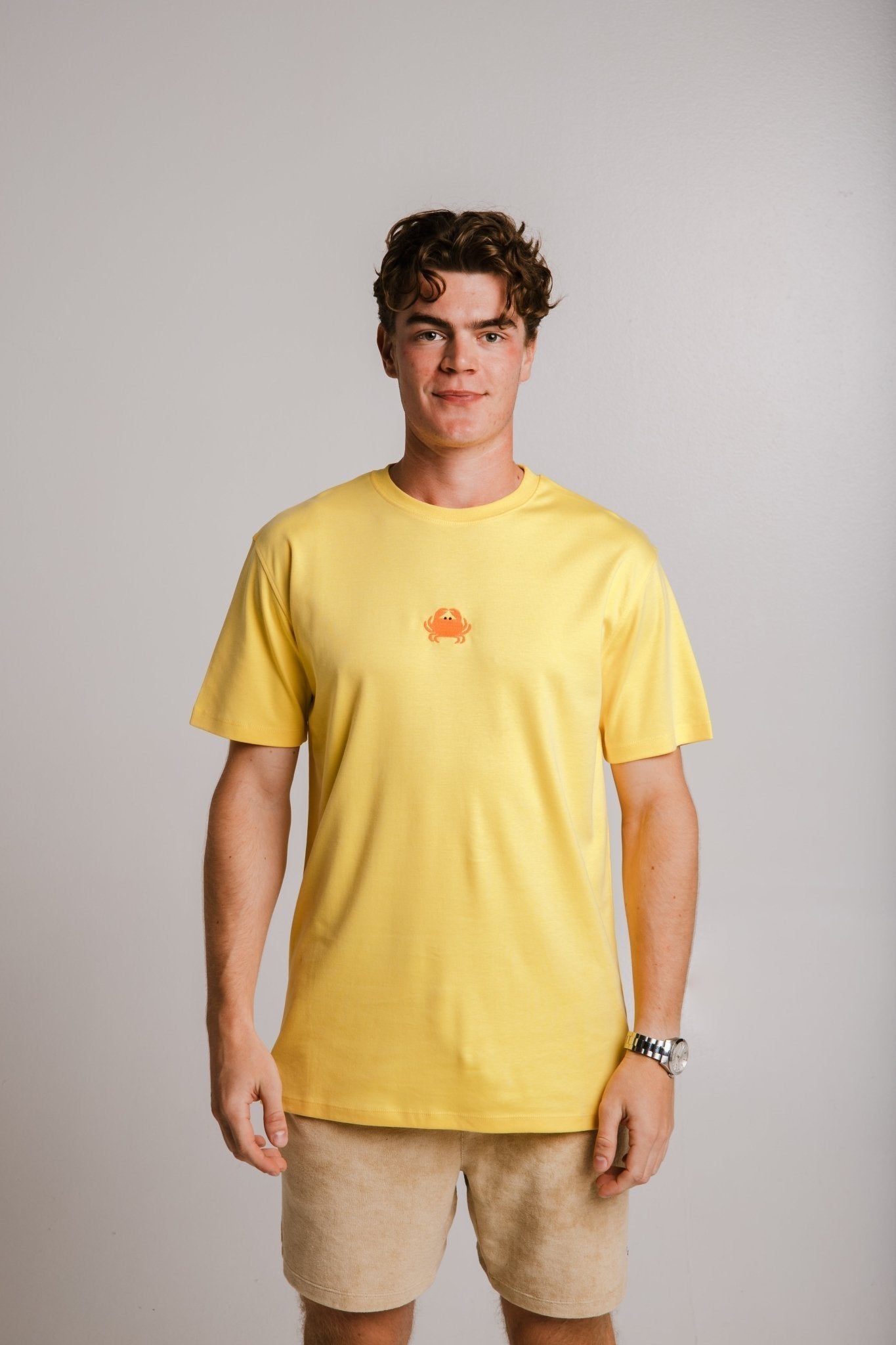 1. Unisex yellow Crab Heavy T-shirt by Sossu worn by male model in studio setting