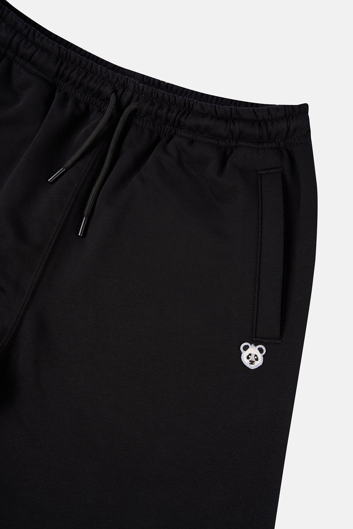 7. Flat lay of unisex black Panda Soft Fleece Sweatpants by Sossu showing front design