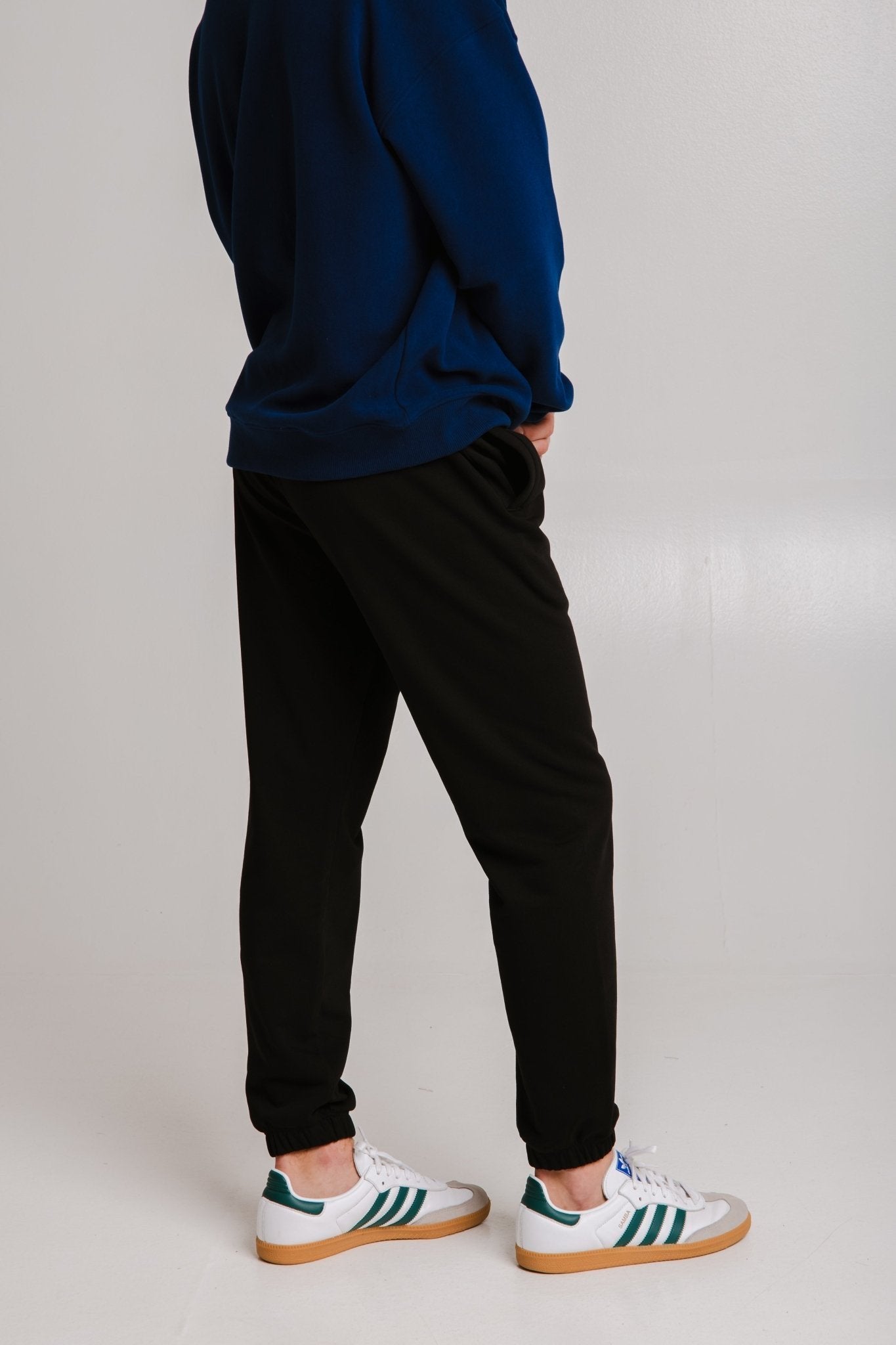 2. Unisex black Panda Soft Fleece Sweatpants by Sossu shown from the back in studio